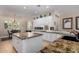 Bright kitchen with granite countertops, stainless steel appliances and tile backsplash at 12835 W Chapala Ct, Sun City West, AZ 85375