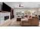 Inviting living room features recessed lighting, ceiling fan and tile fireplace at 12835 W Chapala Ct, Sun City West, AZ 85375
