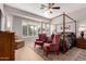 Stately main bedroom features a four-poster bed, plush chairs, and large windows with shutters at 12835 W Chapala Ct, Sun City West, AZ 85375