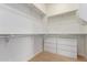 Spacious walk-in closet featuring built-in shelving and drawers for optimal organization and storage solutions at 12835 W Chapala Ct, Sun City West, AZ 85375