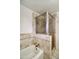 Bathroom featuring a bathtub, shower with glass screen, and decorative tile work at 130 E Coronado Rd # 16, Phoenix, AZ 85004