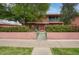 Two-story exterior featuring lush landscaping, balcony, and gated front yard at 130 E Coronado Rd # 16, Phoenix, AZ 85004