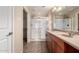 Neutral-toned bathroom features double sinks, large mirror, and a walk-in shower at 14575 W Mountain View Blvd # 621, Surprise, AZ 85374