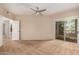 Spacious bedroom features a modern ceiling fan and sliding glass door to an outdoor balcony at 14575 W Mountain View Blvd # 621, Surprise, AZ 85374