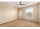 Bedroom with neutral walls, carpet, and a large window at 14575 W Mountain View Blvd # 621, Surprise, AZ 85374