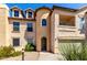 Charming three-story home with a private balcony, two-car garage, and landscaped front yard with stone pathway at 14575 W Mountain View Blvd # 621, Surprise, AZ 85374