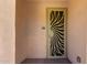 Close-up of the front door featuring a decorative metal security screen and unit number for added safety at 14575 W Mountain View Blvd # 621, Surprise, AZ 85374