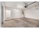 Empty two car garage with concrete floor and hot water heater at 14575 W Mountain View Blvd # 621, Surprise, AZ 85374