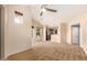 Expansive living area featuring high ceilings, plush carpeting, and windows offering ample natural light and ventilation at 14575 W Mountain View Blvd # 621, Surprise, AZ 85374