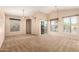 Spacious living room with plush carpeting, abundant natural light, and a sliding glass door to the patio at 14575 W Mountain View Blvd # 621, Surprise, AZ 85374