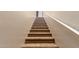 Carpeted staircase with white railing leads to the next level, enhancing accessibility and comfort in the home at 14575 W Mountain View Blvd # 621, Surprise, AZ 85374