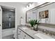 Stylish bathroom with double sinks, granite counters and a view of the tiled shower at 14841 N 62Nd Way, Scottsdale, AZ 85254