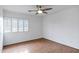 Bright, empty bedroom with wood floors and a window with wood-framed blinds at 14841 N 62Nd Way, Scottsdale, AZ 85254