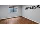 Spacious bedroom with laminate flooring and a window providing natural light. The room is marked with the word LIMITLESS at 14841 N 62Nd Way, Scottsdale, AZ 85254