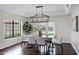 Elegant dining room with a modern chandelier, a large window, and stylish furniture at 14841 N 62Nd Way, Scottsdale, AZ 85254