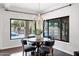 Bright dining area features a modern chandelier and large windows overlooking the pool and landscaped yard at 14841 N 62Nd Way, Scottsdale, AZ 85254