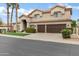 Two-story home with a tile roof, lush lawn, mature trees, and ample driveway space at 14841 N 62Nd Way, Scottsdale, AZ 85254