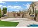 Outdoor stone fireplace creates a cozy ambiance in the backyard, ideal for gatherings at 14841 N 62Nd Way, Scottsdale, AZ 85254