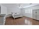 Spacious main bedroom features wood floors, a ceiling fan and white trim at 14841 N 62Nd Way, Scottsdale, AZ 85254