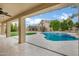 Covered patio overlooking the backyard with a pool, spa and outdoor kitchen at 14841 N 62Nd Way, Scottsdale, AZ 85254
