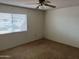 Spacious bedroom featuring a ceiling fan, window, and neutral paint at 16805 N 110Th Ave, Sun City, AZ 85351