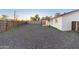 A spacious backyard boasts a rock landscape, fenced perimeter, and covered patio at 1718 S Marilyn Ann Dr, Tempe, AZ 85281