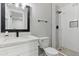 Modern bathroom with glass shower, white subway tile, dark fixtures, and light countertops at 1718 S Marilyn Ann Dr, Tempe, AZ 85281