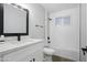 Clean bathroom featuring white subway tile, black fixtures, quartz countertop vanity and a combo tub/shower at 1718 S Marilyn Ann Dr, Tempe, AZ 85281