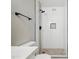 Walk-in shower with white subway tile, dark fixtures, mosaic accent wall, and pebble floor at 1718 S Marilyn Ann Dr, Tempe, AZ 85281