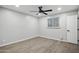 A light and airy bedroom features wood-look floors and a ceiling fan at 1718 S Marilyn Ann Dr, Tempe, AZ 85281