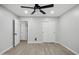 Bedroom featuring a ceiling fan, wood-look floors, and grey painted walls at 1718 S Marilyn Ann Dr, Tempe, AZ 85281