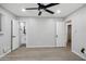 Light-filled bedroom with light grey walls, wood-look floors and an en-suite bathroom at 1718 S Marilyn Ann Dr, Tempe, AZ 85281