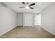 Neutral bedroom with wood-look flooring, closet, ceiling fan, and white walls at 1718 S Marilyn Ann Dr, Tempe, AZ 85281