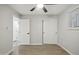 A charming bedroom with wood floors and light grey walls next to a bathroom at 1718 S Marilyn Ann Dr, Tempe, AZ 85281