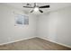 An inviting bedroom with a ceiling fan, wood-look flooring, and lots of natural light at 1718 S Marilyn Ann Dr, Tempe, AZ 85281
