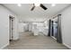 Open concept kitchen features modern white cabinets, island with a sink, and sliding glass door access to the backyard at 1718 S Marilyn Ann Dr, Tempe, AZ 85281