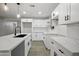 Modern kitchen featuring white cabinets, quartz countertops, and a black faucet with recessed lighting at 1718 S Marilyn Ann Dr, Tempe, AZ 85281