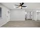 Spacious living room featuring a ceiling fan and multiple hallways leading to other rooms at 1718 S Marilyn Ann Dr, Tempe, AZ 85281