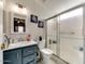 Updated bathroom with blue vanity, bright mirror and a clean, glass-enclosed shower stall at 17200 W Bell Rd # 1643, Surprise, AZ 85374