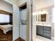 Hallway featuring a stacked washer/dryer and bathroom with modern vanity and fixtures at 17200 W Bell Rd # 1643, Surprise, AZ 85374