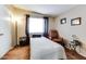 Cozy bedroom with neutral walls, bright window, and simple furnishings at 17200 W Bell Rd # 1643, Surprise, AZ 85374