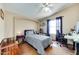 Bedroom featuring a queen bed, ceiling fan, and dedicated desk space at 17200 W Bell Rd # 1643, Surprise, AZ 85374