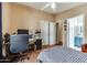 Cozy bedroom with a ceiling fan and a desk, adjacent to the bathroom for added convenience at 17200 W Bell Rd # 1643, Surprise, AZ 85374