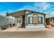 Inviting single-level home features a covered carport and well-manicured landscaping at 17200 W Bell Rd # 1643, Surprise, AZ 85374
