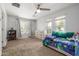 Bright bedroom featuring a ceiling fan, carpeted floors, and a window offering natural light at 18543 E Purple Sage Dr, Queen Creek, AZ 85142