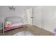 bedroom featuring a crib with a pink pillow, closet, and carpeted flooring at 18543 E Purple Sage Dr, Queen Creek, AZ 85142
