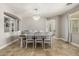 Light-filled dining room features tiled floors, a stylish chandelier, and convenient access to living areas at 18543 E Purple Sage Dr, Queen Creek, AZ 85142
