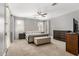 This primary bedroom boasts ample space, soft carpeting, and neutral paint at 18543 E Purple Sage Dr, Queen Creek, AZ 85142