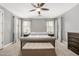 The primary bedroom features soft carpeting, neutral paint, and a ceiling fan at 18543 E Purple Sage Dr, Queen Creek, AZ 85142