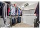 Walk-in closet featuring two rods for hanging clothes, shelves, and tile flooring at 18543 E Purple Sage Dr, Queen Creek, AZ 85142